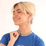 Woman smiling in sterling silver stackable necklaces